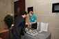 An alumni collecting their name badge