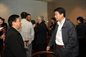 Xiang Zhou talking to a fellow alumni