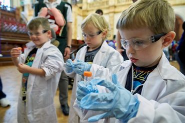 Future scientists in lab coats and goggles