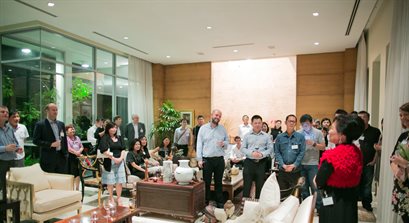 Large group of Singapore alumni listening to a speaker