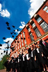 Photo of students celebrating graduation outside the main library