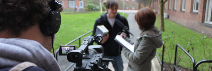 Photograph of students filming an interview