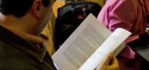 Photo of research student reading a publication.