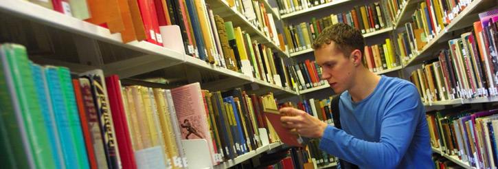 Photograph of a male student in the library
