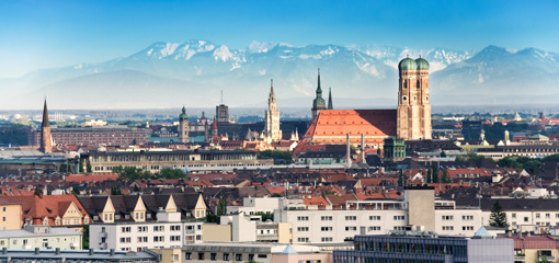 Photograph of Munich with mountains in the background
