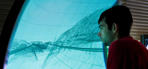 Photograph of a student interacting with a computer visualisation