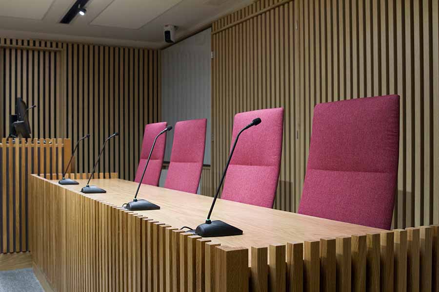 The Law School's mooting room - four chairs for the judges with microphones in front of them.