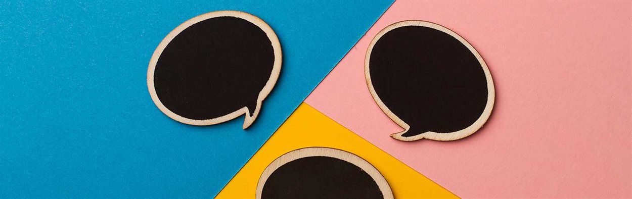 Round empty chalk board speech bubbles on colored papers