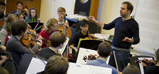 Daniela Rosina conducts orchestra rehearsal