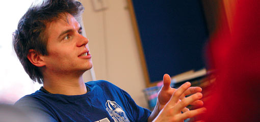 Photograph of a male undergraduate student speaking in a discussion