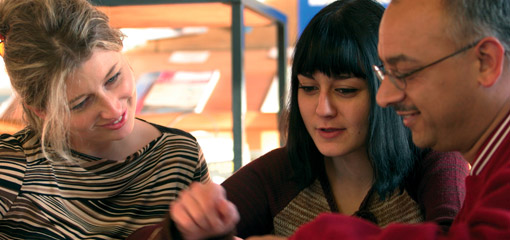 Photograph of three postgraduate students in discussion