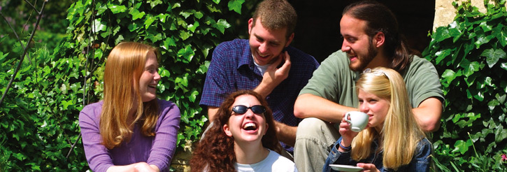 Photograph of laughing students in the Shakespeare Institute garden