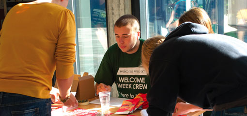 Photograph of students at a Welcome Week desk
