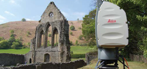 Photograph showing 3D laser scanning equipment and the remains of an abbey wall
