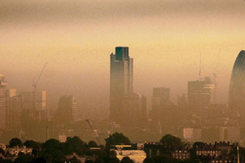 A yellow haze is seen across tall city buildings