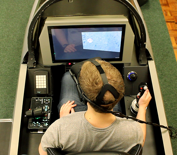 Overhead photo of person using cockpit test bed training facilities