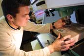 Male student using milling machine