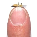 Micro-engine, balanced on a person's fingertip