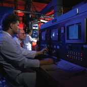 Scientist at control panel