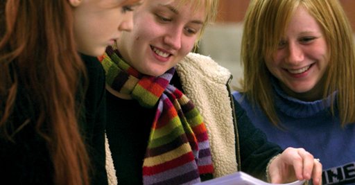 Three students smiling