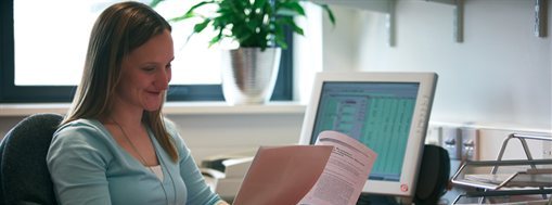 Staff member reading at desk