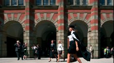 Graduate walking past Law School