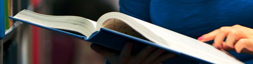 Close up of a student looking through a book