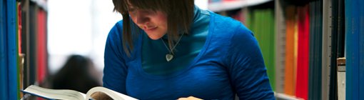 Student looking at a library book