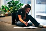 A student reading notes on campus