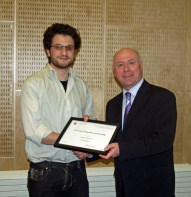 Jeff Bale presenting an award recipient with his framed certificate.