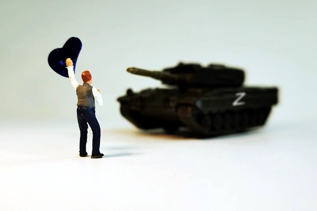 A miniature figure of a tank and a person waving a flag