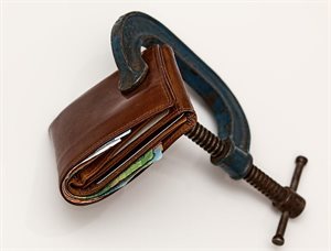 A wallet clamped in a vice