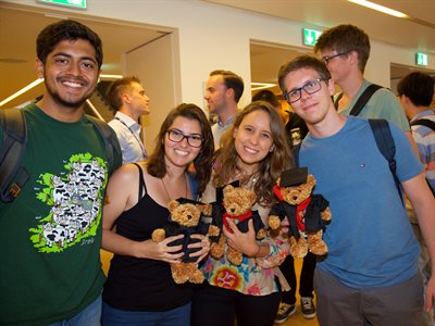 Students at the BISS awards ceremony with their graduate teddy bears