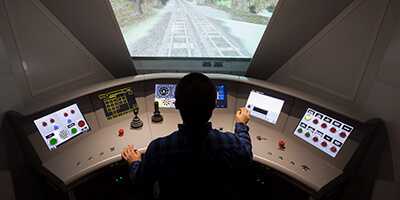 Male researcher operating a train simulator