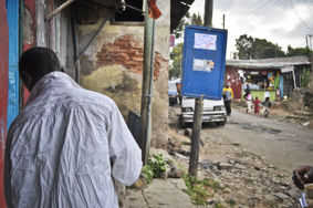 A man stands with his back to the camera on a now demolished street in Arada