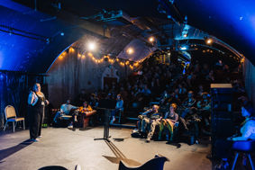 Immersive performance space with live audience.