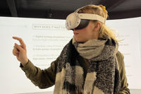 Female student wearing VR headset in training environment