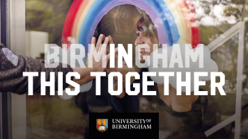 The words Birmingham In This Together over an image of a woman smiling at a friend through a rainbow painted on a window