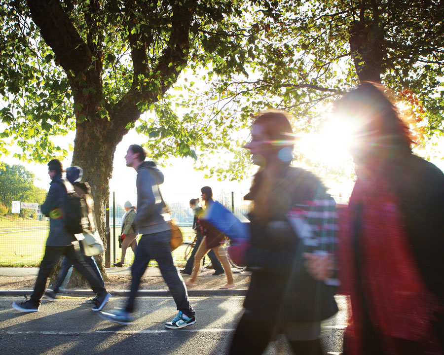 Young people walking onto campus