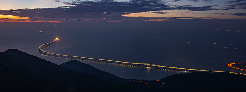 A panoramic image of a bridge at sunset