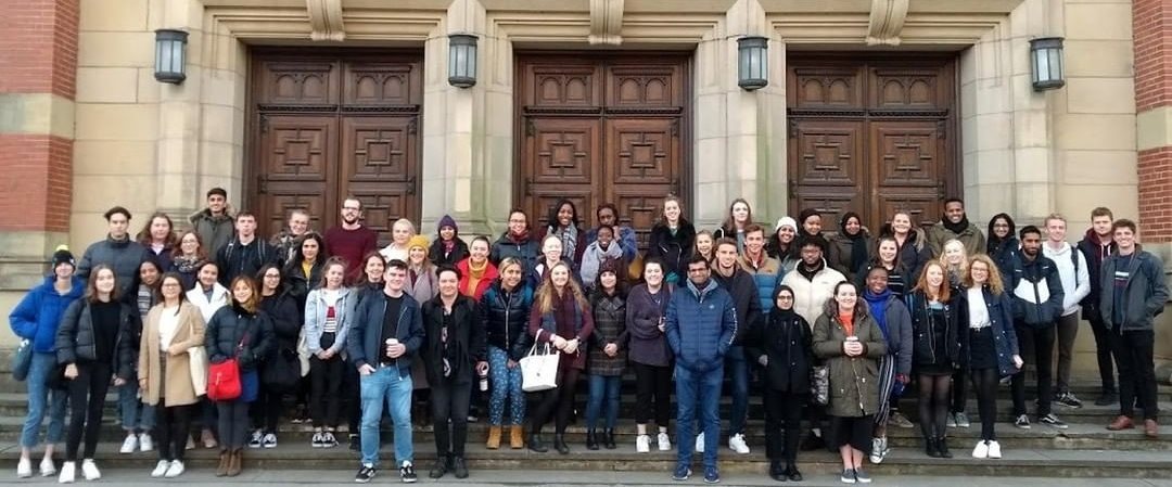 Around 60 student fundraisers together on the steps of the Aston Webb building