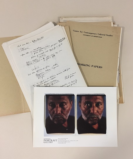Folders and papers from the Stuart Hall archive with a photograph of him.