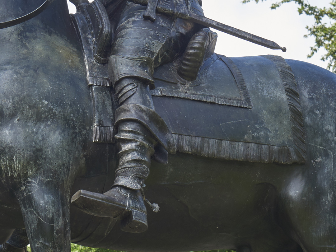 Close up detail of bronze sculpture of King George I on Horseback by John Nost II including boots in stirrups and saddle