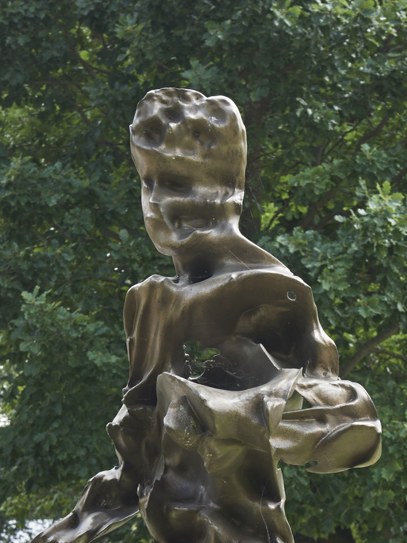 Close crop of upper torso include arms, chest and head of bronze sculpture Father Sky/Uranus by Zachary Eastwood-Bloom showing human angle