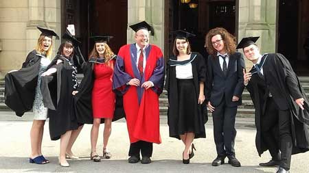 Dr Niall Livingstone with some of his students at a graduation ceremony