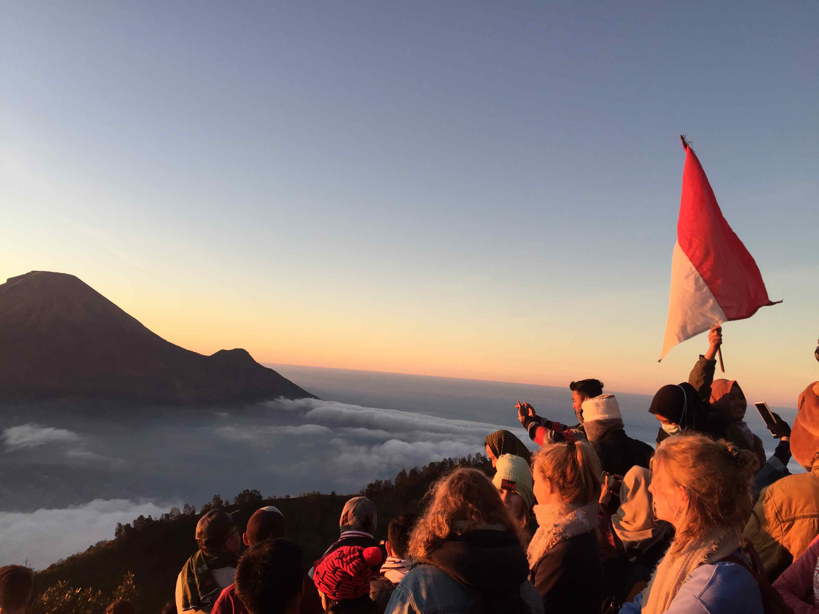 Sunrise on Indonesian Independence Day. We hiked up the mountain before the sun rose and hundreds of people sang the Indonesian national anthem'