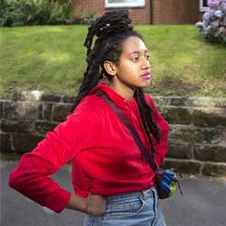 portrait of Danni Ebanks Ingram standing in a street with her hands on her hips