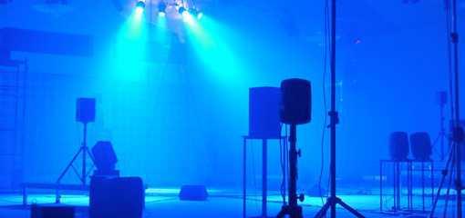 Speakers set up under blue lighting