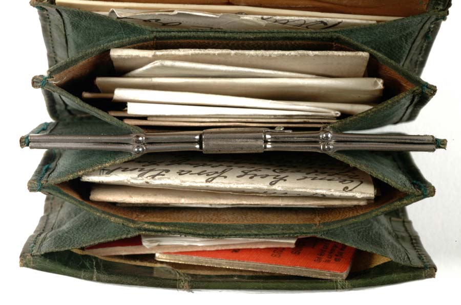 Photograph looking into the compartments inside the purse, which are full of letters and booklets