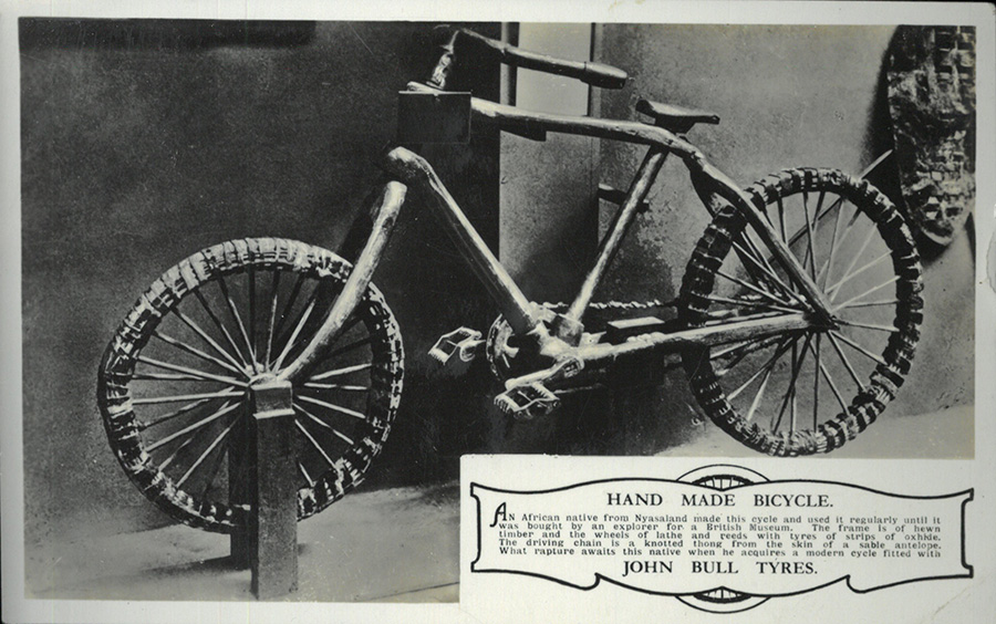 A postcard depicting a wooden bicycle on display at the 1924 British Empire Exhibition. It includes the caption explored in the paragraph above.